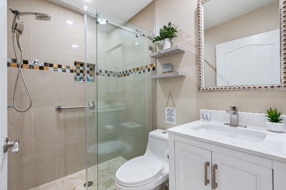 Baño con ducha de cristal y lavabo